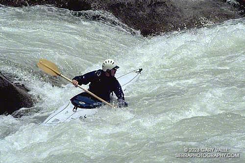 A boater uses a break in a river-wide ledge to work out of a hole, just below the main drop on Vortex Rapid.